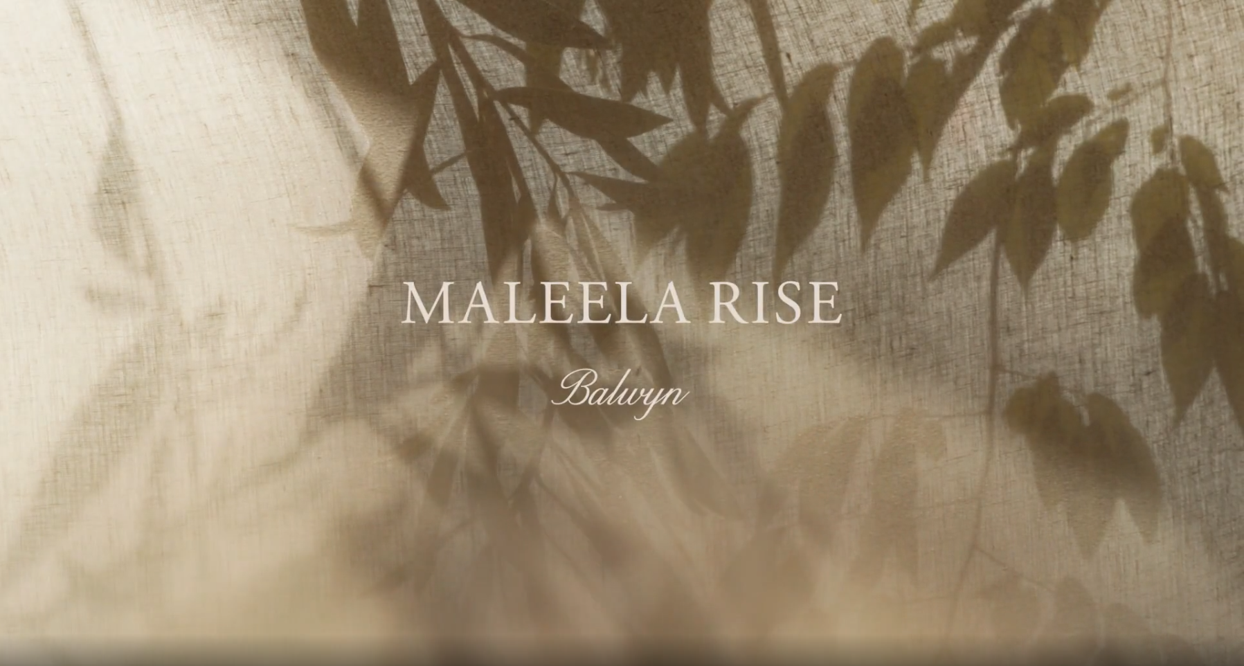Text MALEELA RISE, Balwyn is overlaid on a beige fabric backdrop with soft, leafy shadows cast across it, creating a calm and natural atmosphere.